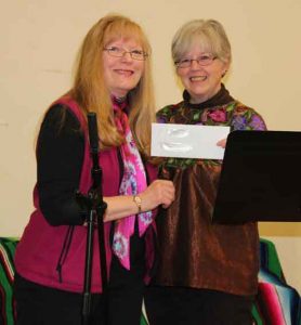 Judith receives check from Kathy Purcell, president of Soroptimist International of Sequim