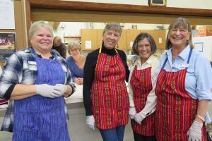 Smiling volunteers, ready to serve